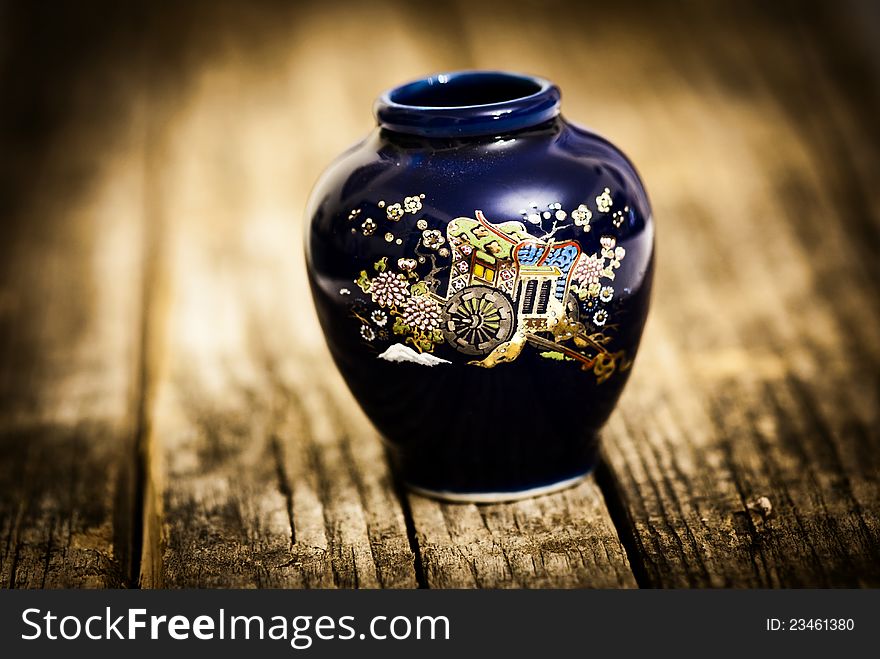 Little vase decorated on wooden old table