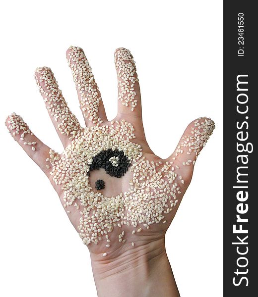 Hand with sesame seeds and adhering pattern yin yang. Hand with sesame seeds and adhering pattern yin yang