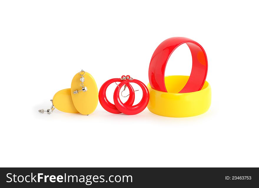 Colored plastic bangles and earrings on white background.  with clipping path. Colored plastic bangles and earrings on white background.  with clipping path