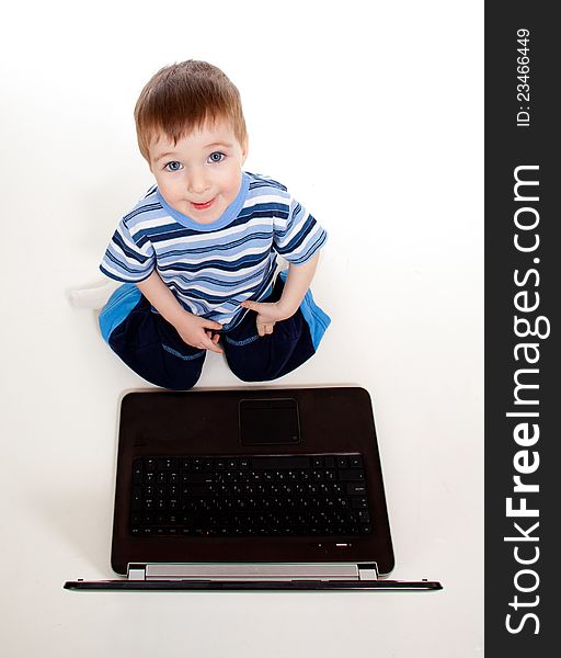 Child using a laptop over white background. Child using a laptop over white background