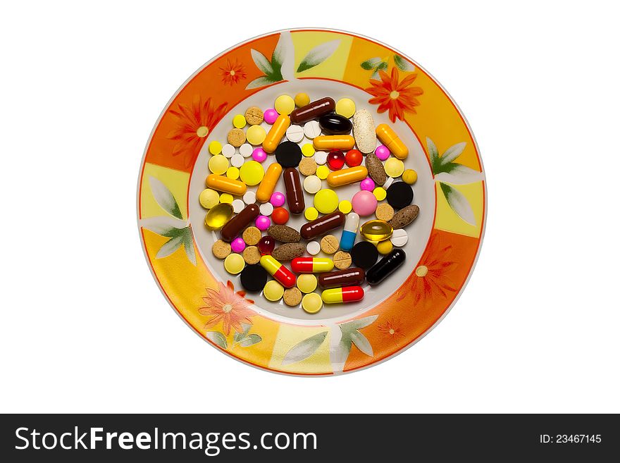 A lot of tablets in a dish isolated on a white background.