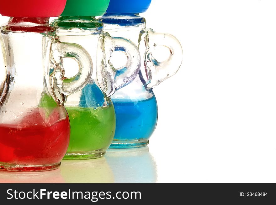 Bottles with a handle with colored liquid on white background