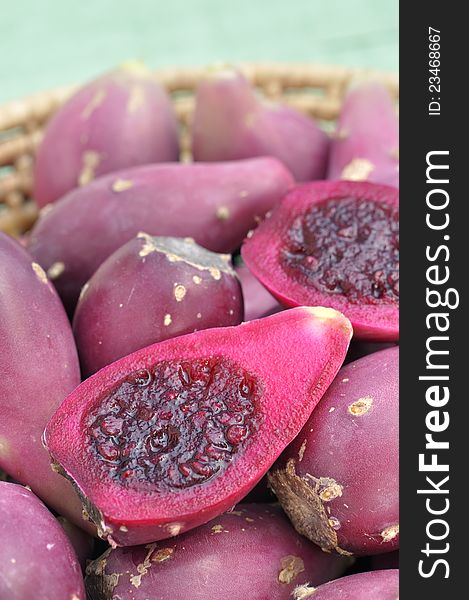 Closeup of sliced halves of cactus pears in basket