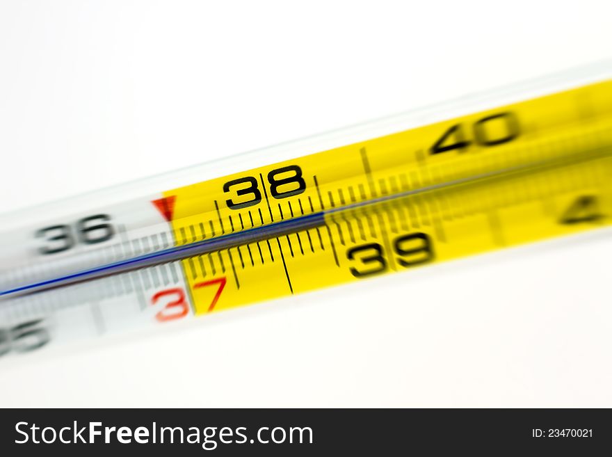 Close-up shot of a medical thermometer showing 38.5 with radial blur