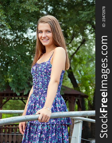 Beautiful girl standing on the bridge in the park. Beautiful girl standing on the bridge in the park