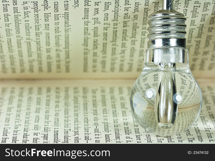 Photo of a light bulb on old book