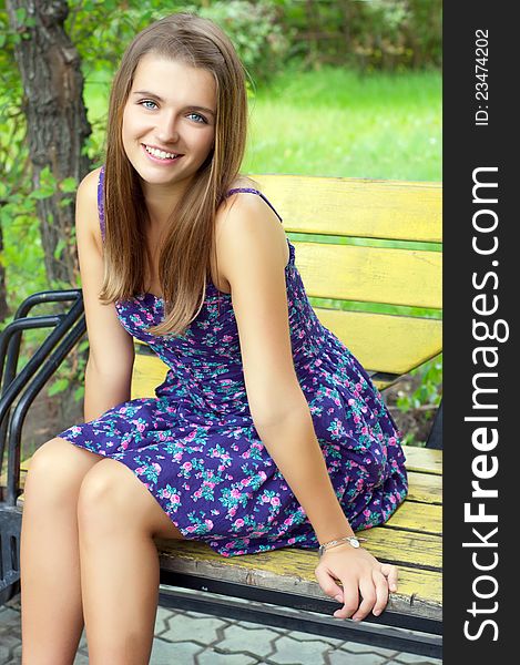 Beautiful girl sitting on a bench