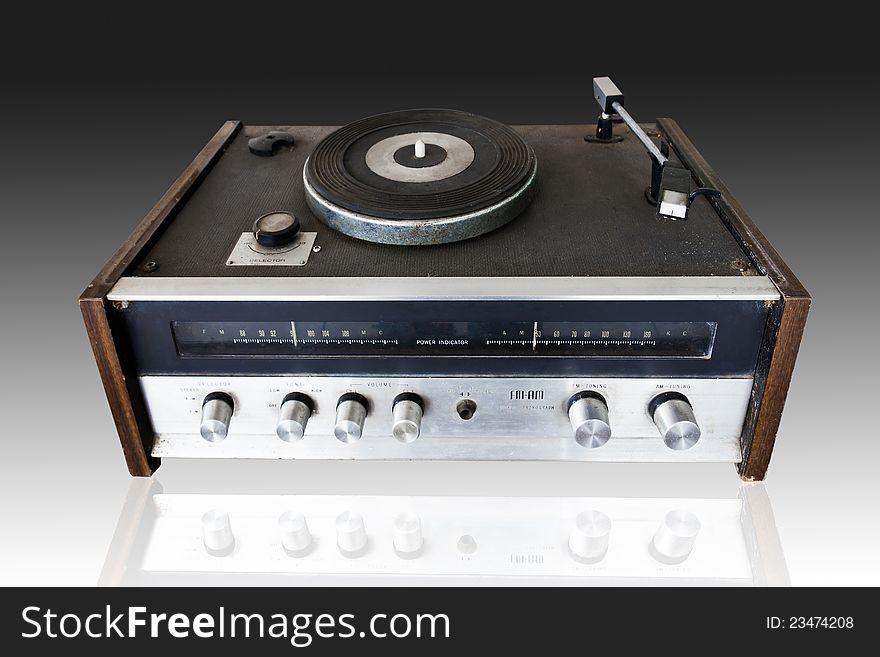 Vintage record player with radio tuner isolated on black background