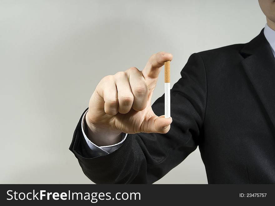 Handsome guy displays cigarettes against. Handsome guy displays cigarettes against