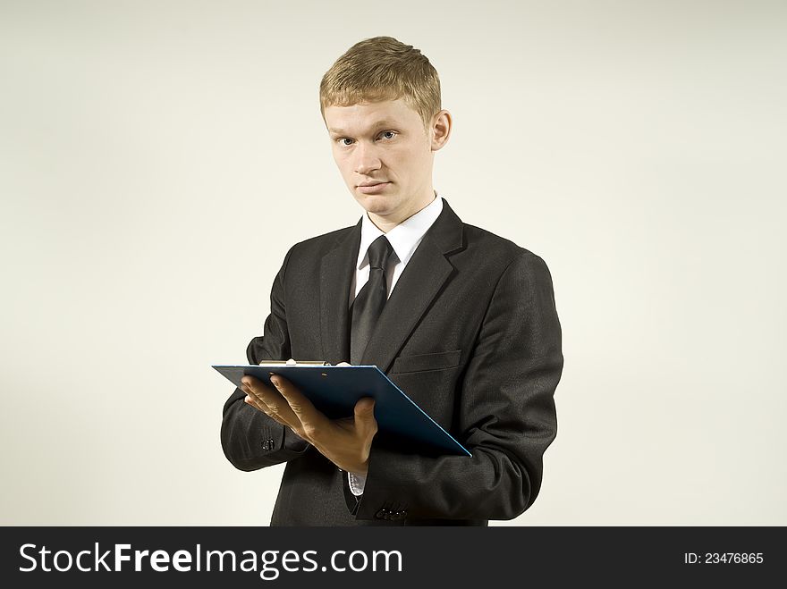 A young guy in a suit against writing. A young guy in a suit against writing