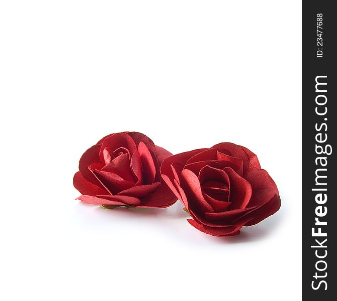 Two red paper roses isolated on a white background. Copy space. Two red paper roses isolated on a white background. Copy space.