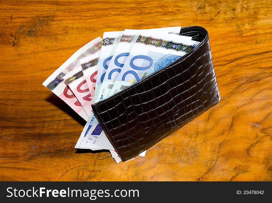 Euros In  Wallet, On Vintage Brown Backgroun