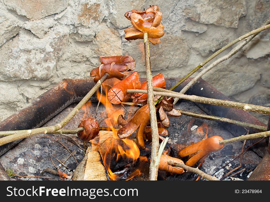 Grilling sausages over open fire outdoor. Grilling sausages over open fire outdoor