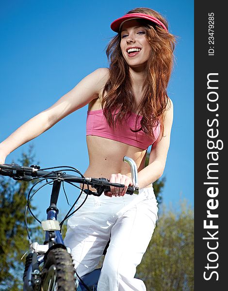 Woman On A Bicykle Outdoors Smiling