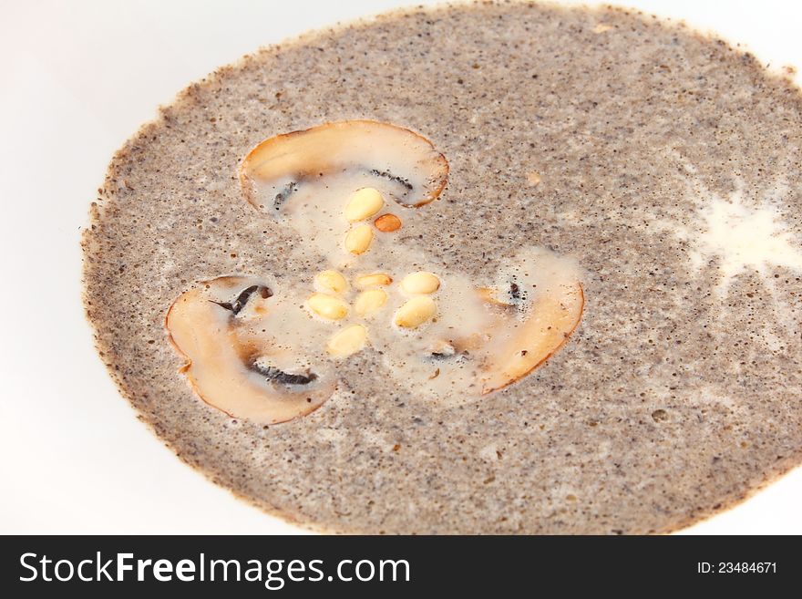 Mushroom cream soup in white plate close up