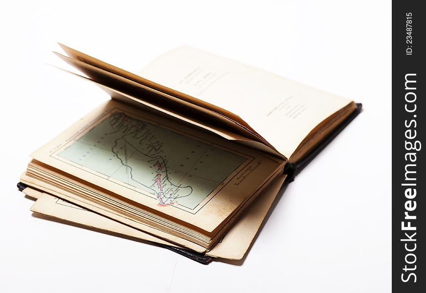 Open old map book on white background