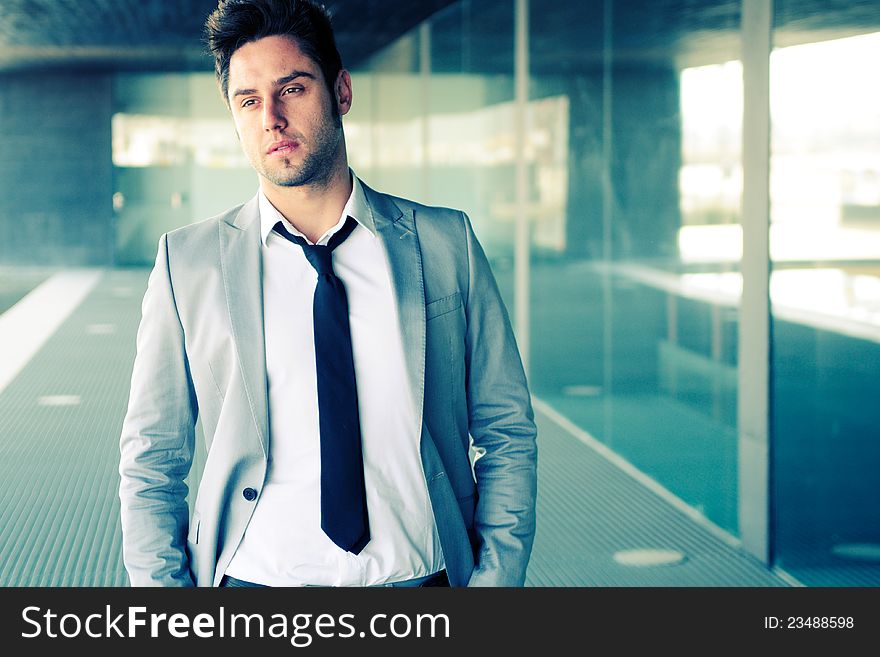 Attractive young businessman in office building