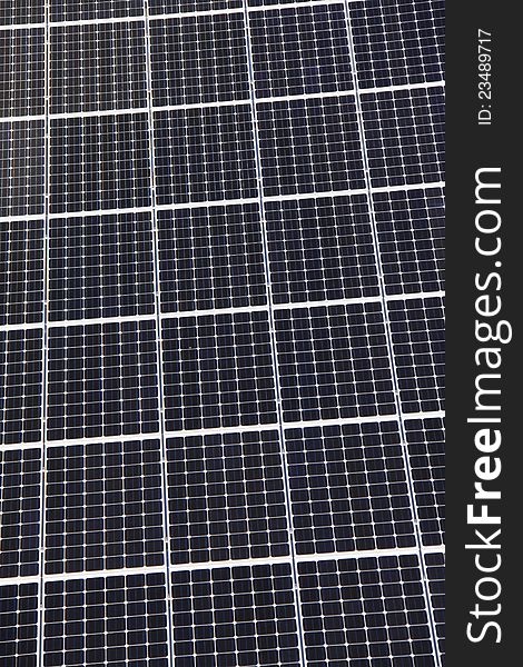 A top down close up view of the grid pattern and surface of rooftop solar panels. A top down close up view of the grid pattern and surface of rooftop solar panels.