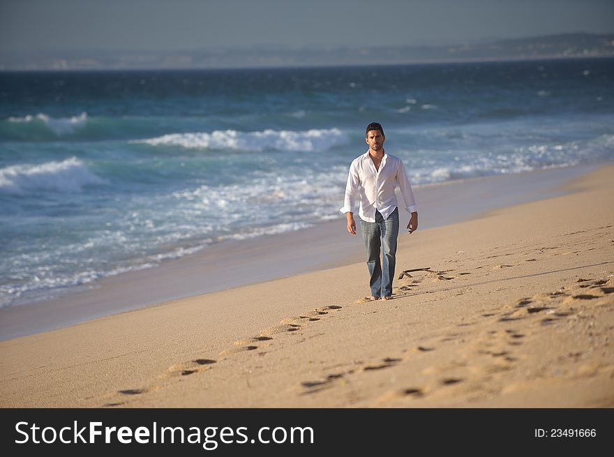 Beautiful man walking alone in desert beach. Beautiful man walking alone in desert beach