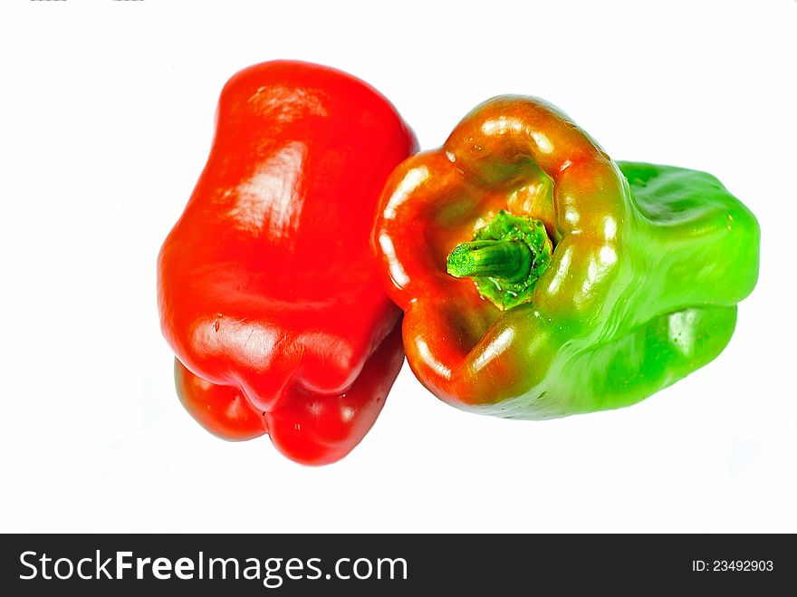 An isolated image of a red bell pepper in gray background with dark shadows. An isolated image of a red bell pepper in gray background with dark shadows.