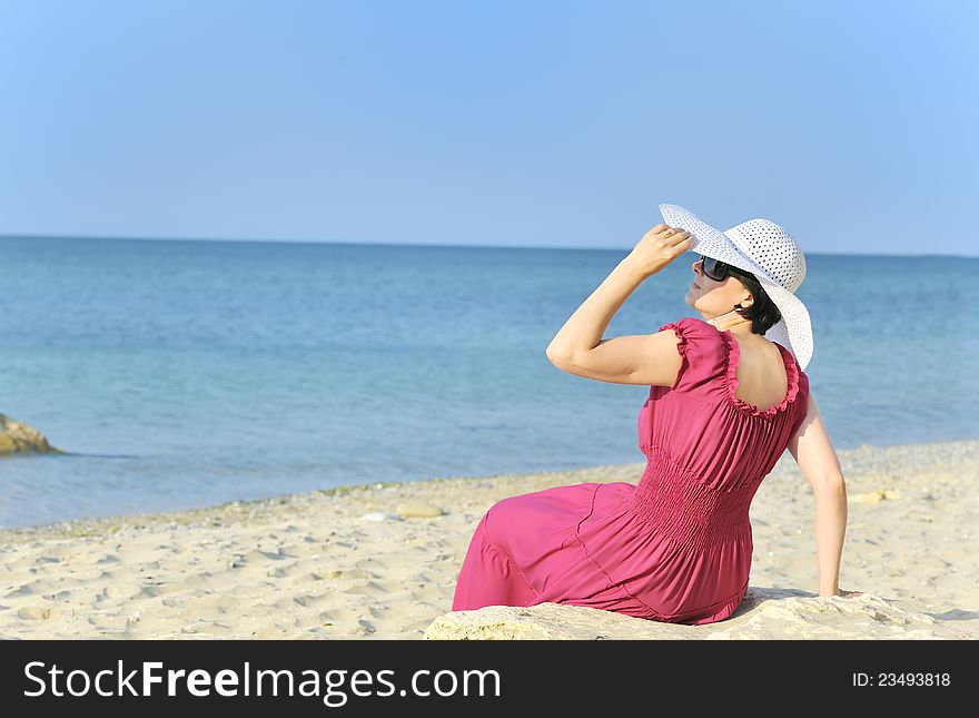 Young woman portrait on the beach in summer time