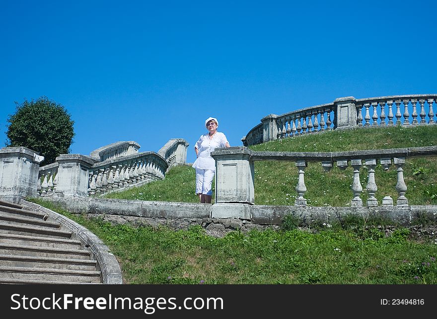 A woman standing on a shaft in the Garden of Venus. Peterhof. Russia. A woman standing on a shaft in the Garden of Venus. Peterhof. Russia