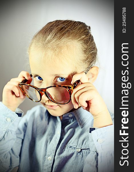 Schoolgirl with big glasses blue eye