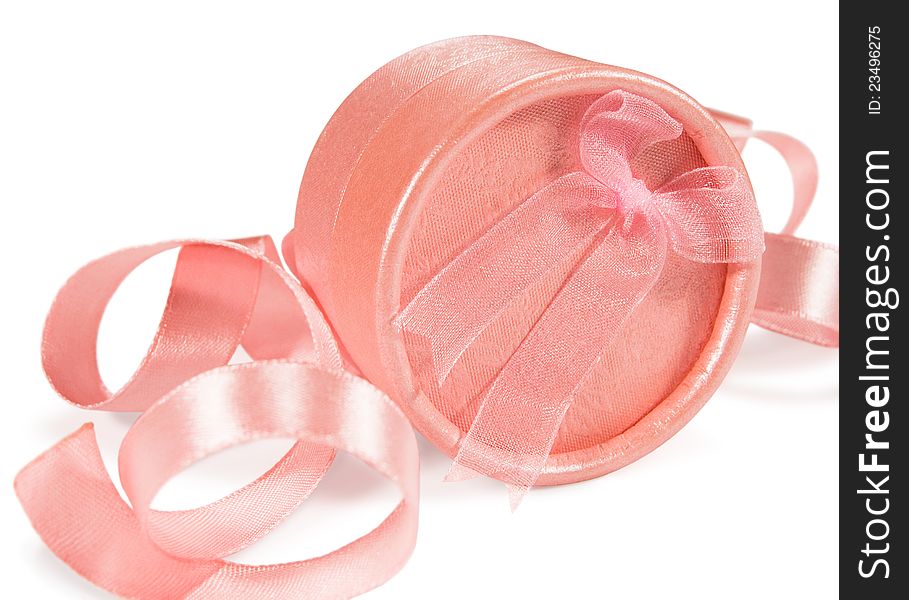 Pink gift box against a background of silk ribbons