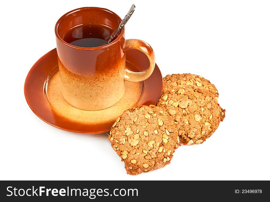 Big brown cup of tea and oatmeal cookies with peanut on a white background.