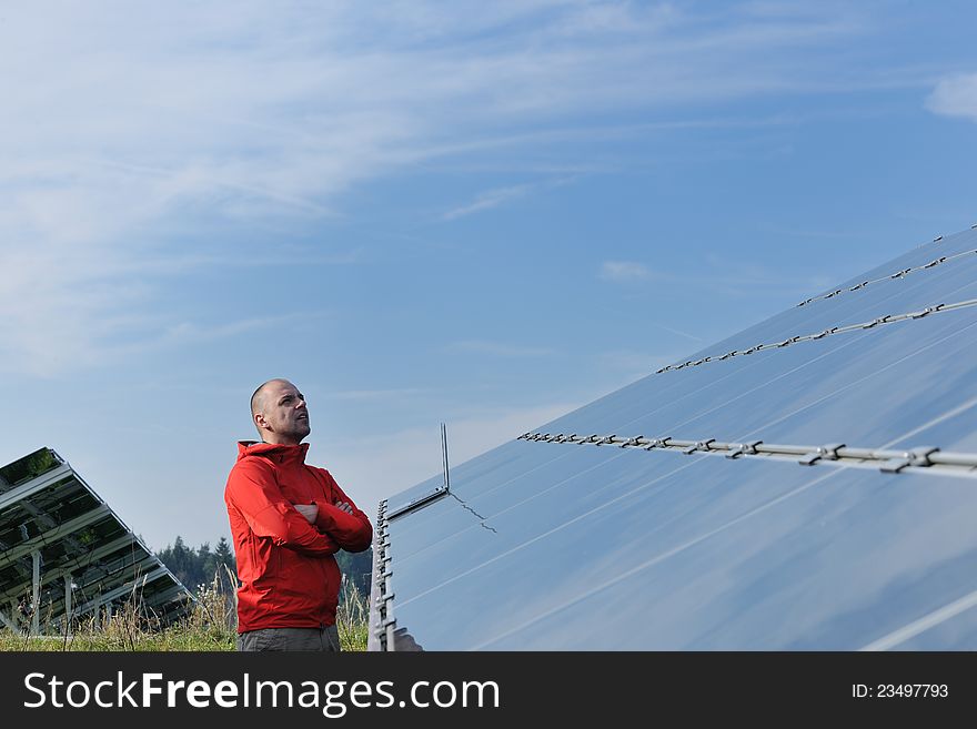 Business man engineer using laptop at solar panels plant eco energy field in background. Business man engineer using laptop at solar panels plant eco energy field in background