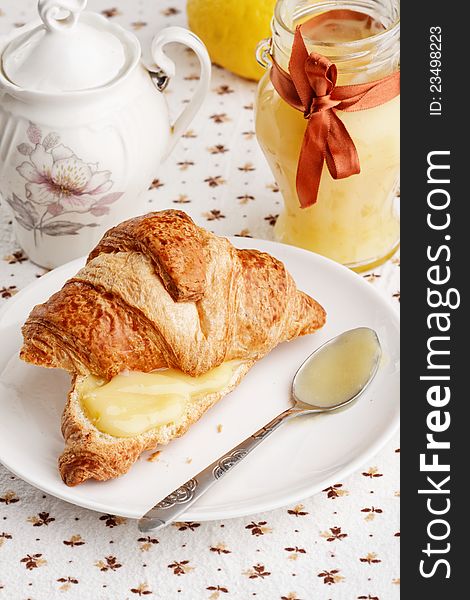 Breakfast with milk, lemon curd and croissants