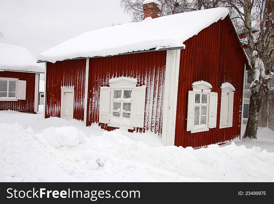 Typical Swedish red cottage in the countryside, Sweden during a snowy winter