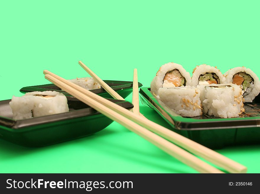 Picture of chopsticks with salmon sushi rolls