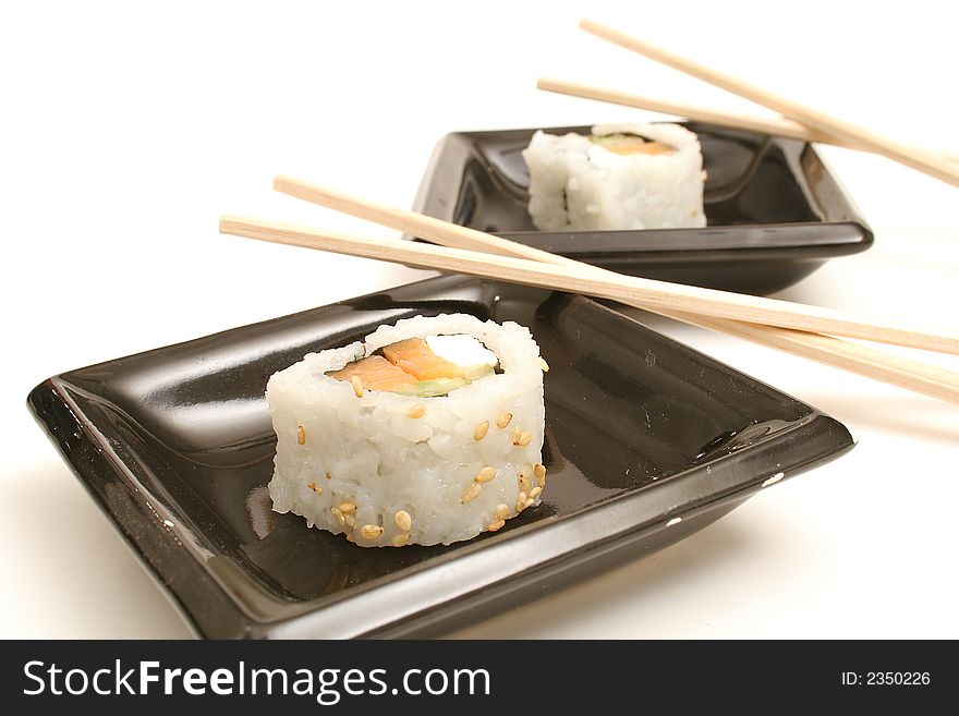 Picture of Two pieces of smoked salmon sushi on white