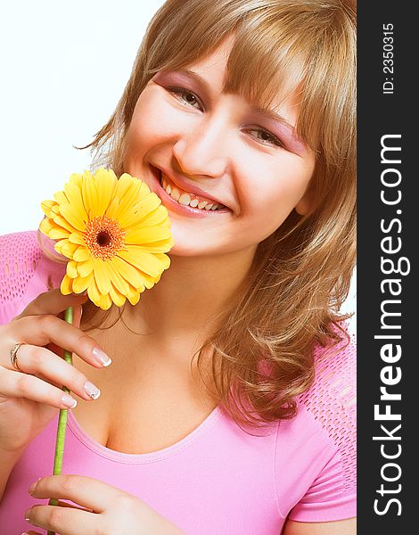 Young women in pink holding a yellow flower isolated on white background. Young women in pink holding a yellow flower isolated on white background