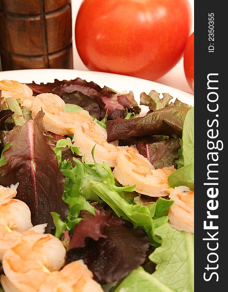 Picture of shrimp skewers on salad vertical