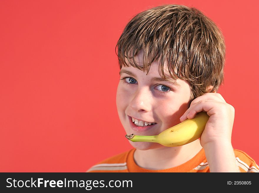 Pic of kid on fruit phone. Pic of kid on fruit phone