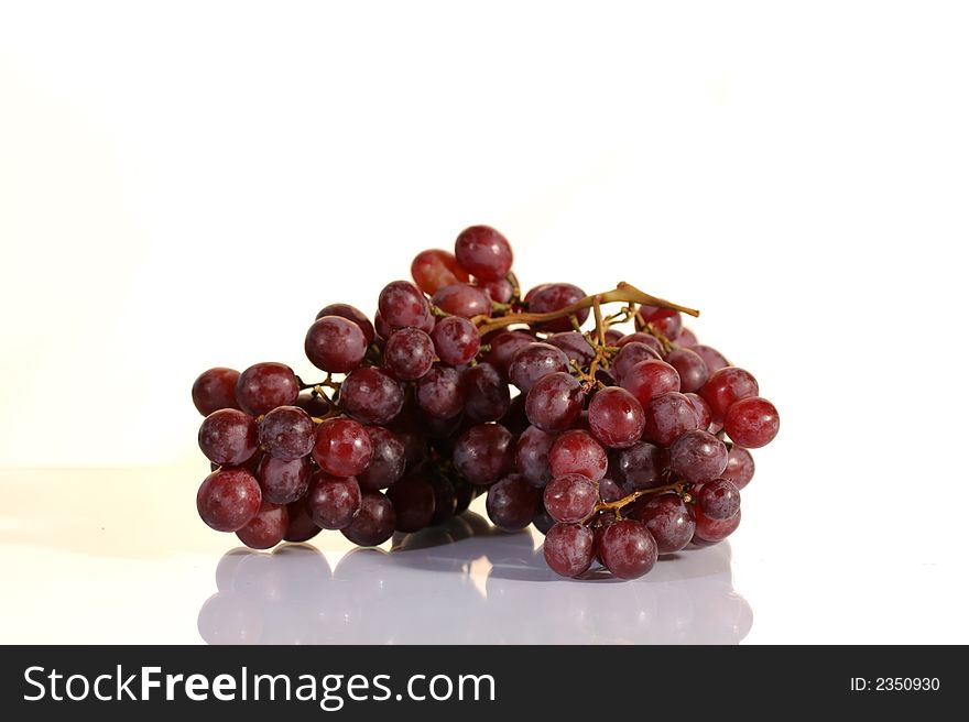 Red grape cluster on a white background