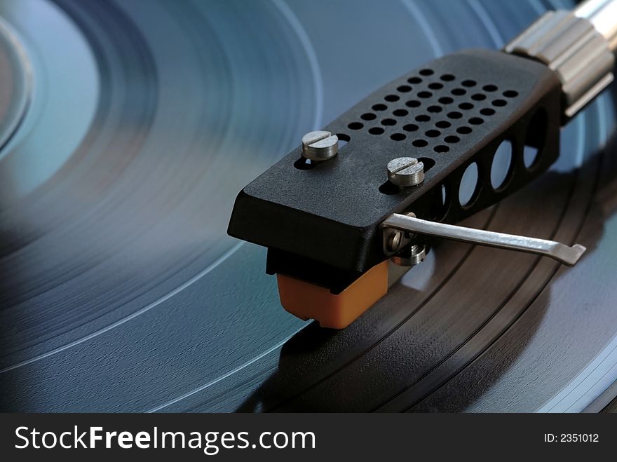Vintage turntable closeup with record playing. Vintage turntable closeup with record playing