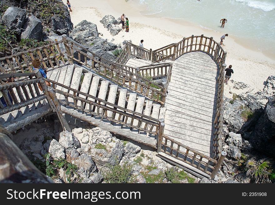 Long staircase going down a cliff to a beach. Long staircase going down a cliff to a beach