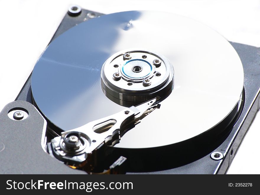 Opened hard drive on white background, closeup of head and disc. Opened hard drive on white background, closeup of head and disc