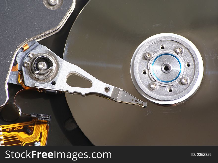 Opened hard drive on white background, closeup of head and disc. Opened hard drive on white background, closeup of head and disc