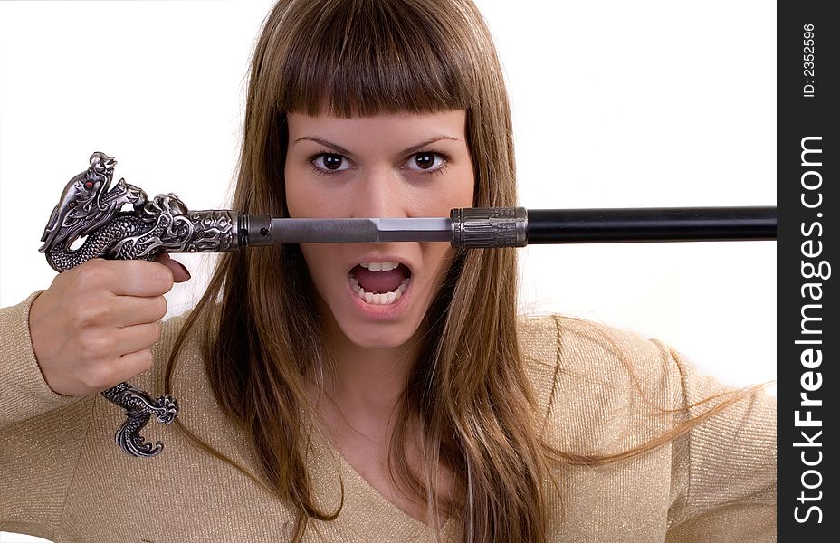 Girl holding a dagger posing against white background. Girl holding a dagger posing against white background