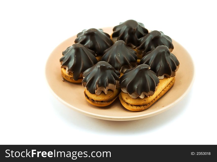 Beautiful cookies with chocolate on a plate on a white background