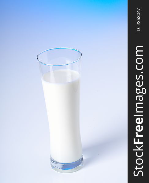 Glass of fresh milk and blue