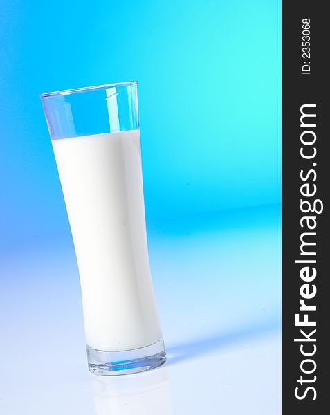 Glass of fresh milk and blue