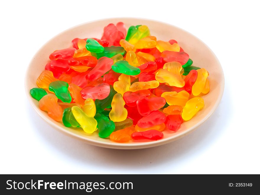 Beautiful fruit candy on a plate on a white background