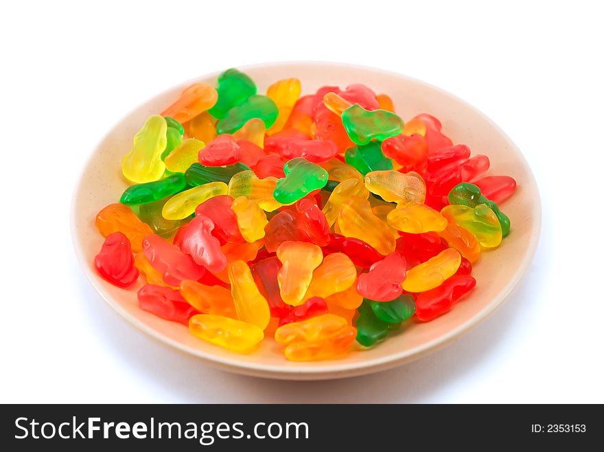 Beautiful fruit candy on a plate on a white background