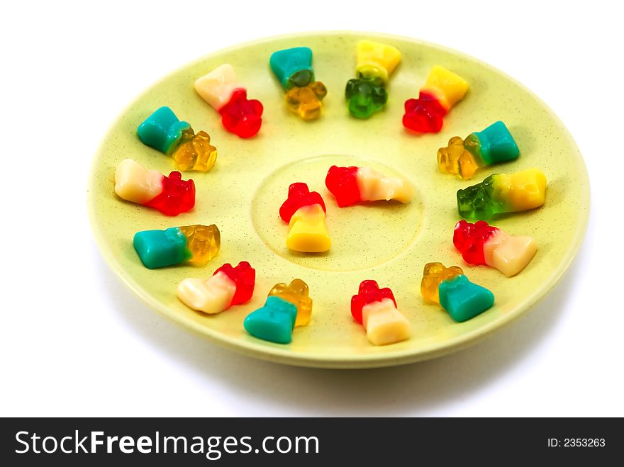 Beautiful fruit candy on a plate on a white background