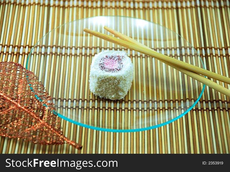 Beautiful cake in a plate on a bamboo napkin